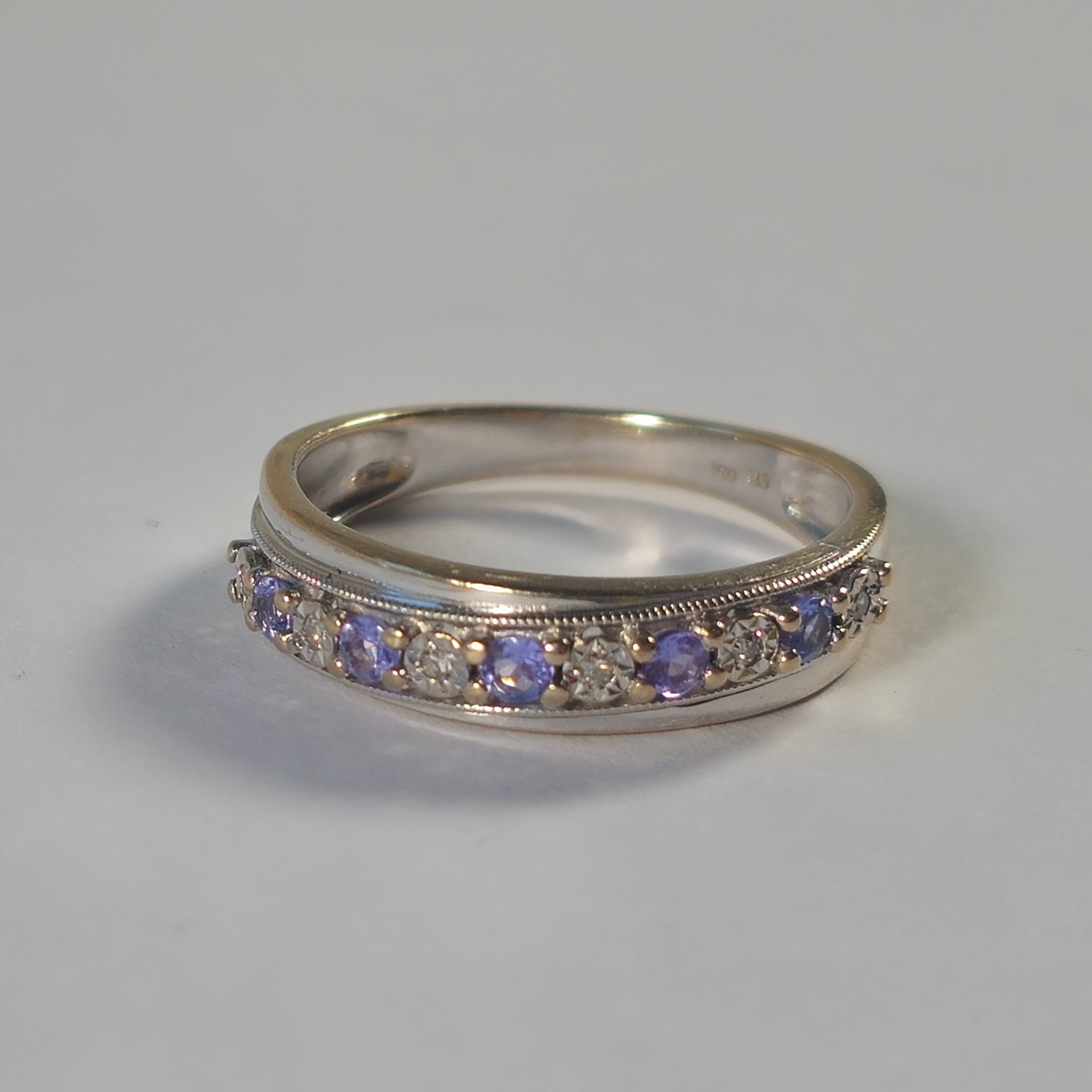 Product photo for 9ct Fading White Gold Diamond & Tanzanite Half Band Ring Size M