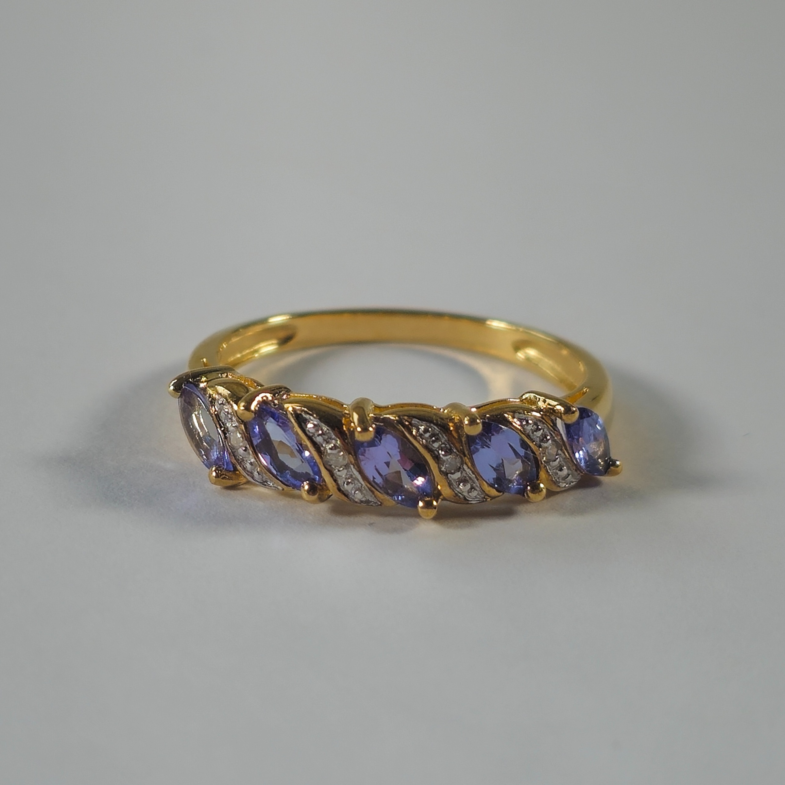 Product photo for 9ct Gold Marquise Tanzanite & Tiny White Stone Half Band Ring Size O1/2