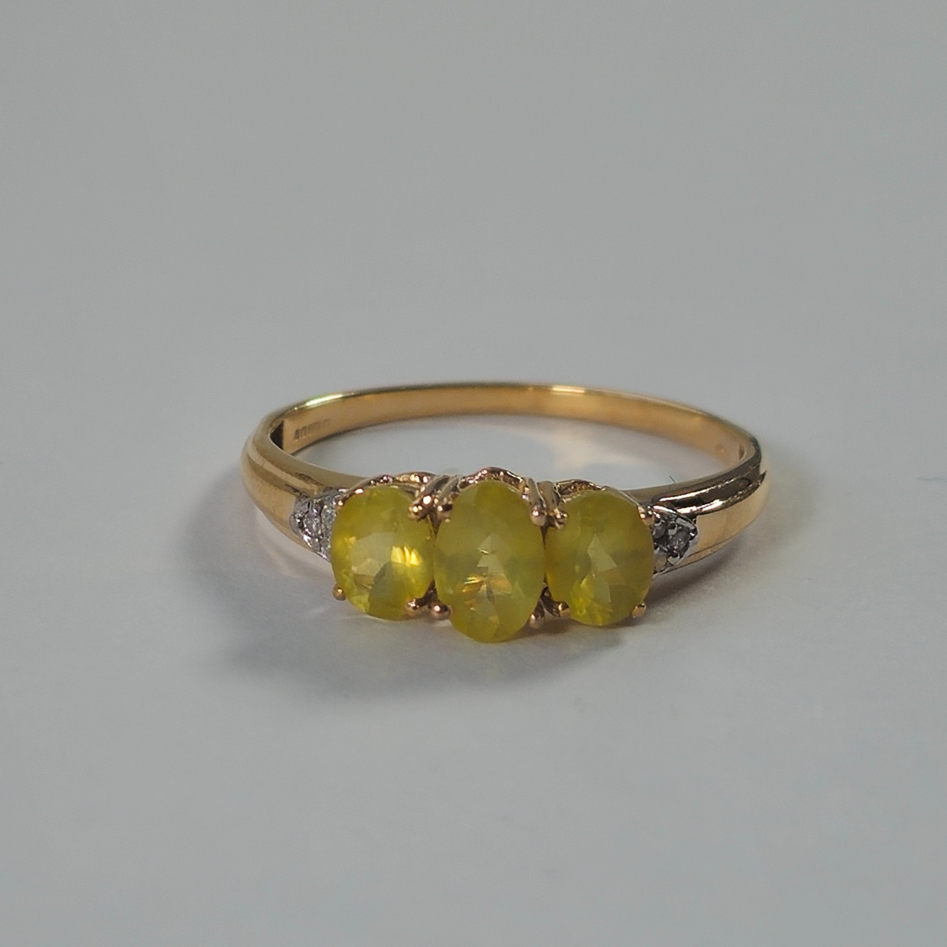 Product photo for 9ct Gold Oval Green Stone & Tiny White Trilogy Ring Size O