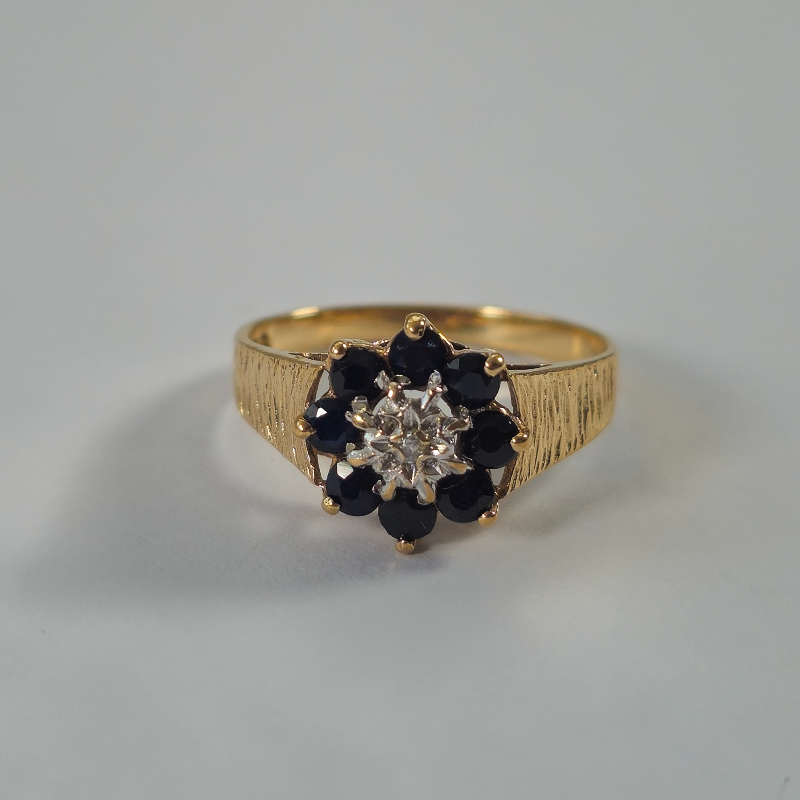 Product photo for 9ct Gold Blue Sapphire & Tiny White Stone Flower Ring Size M