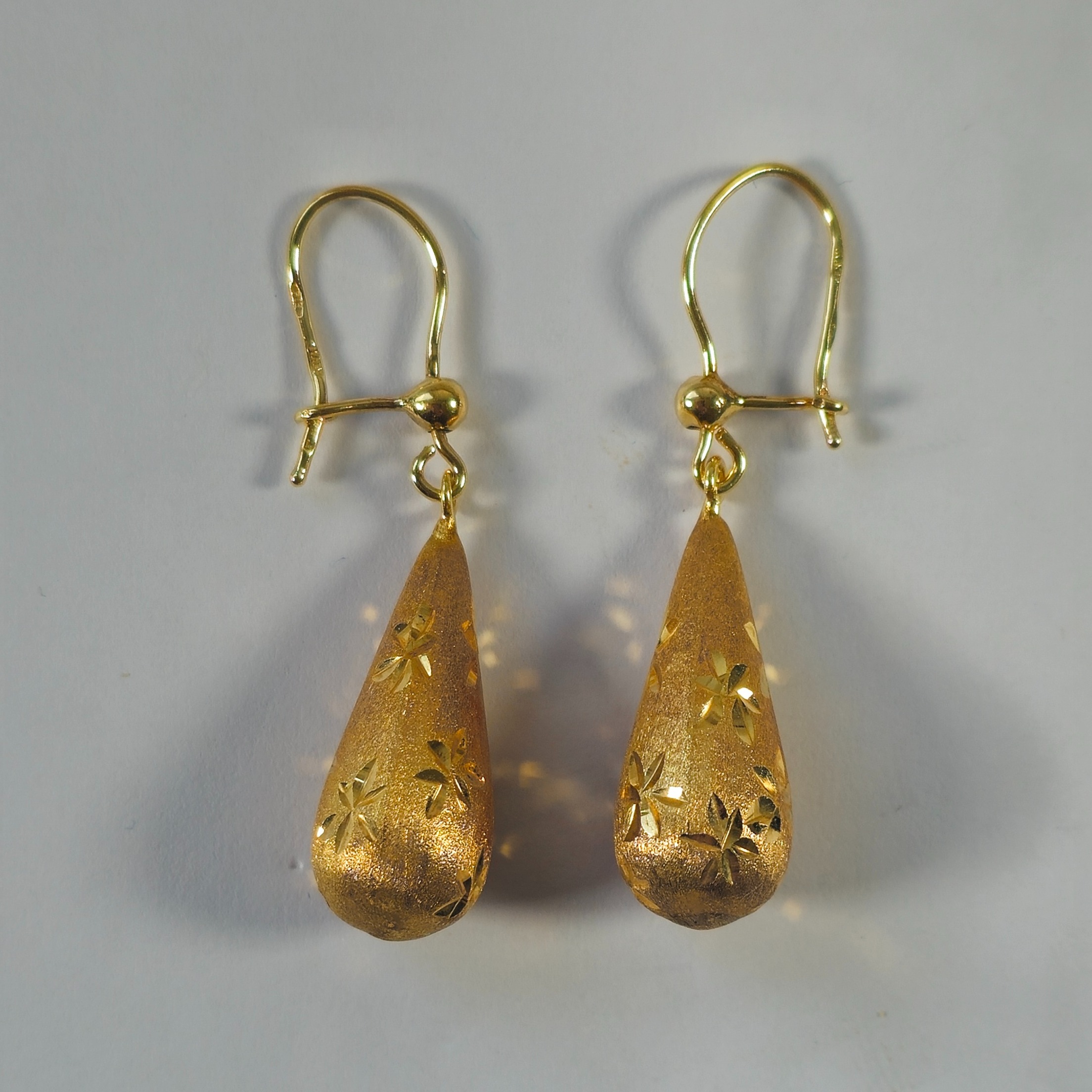 Product photo for 9ct Gold Hollow Tear Drop Star Pattern Hook Earrings