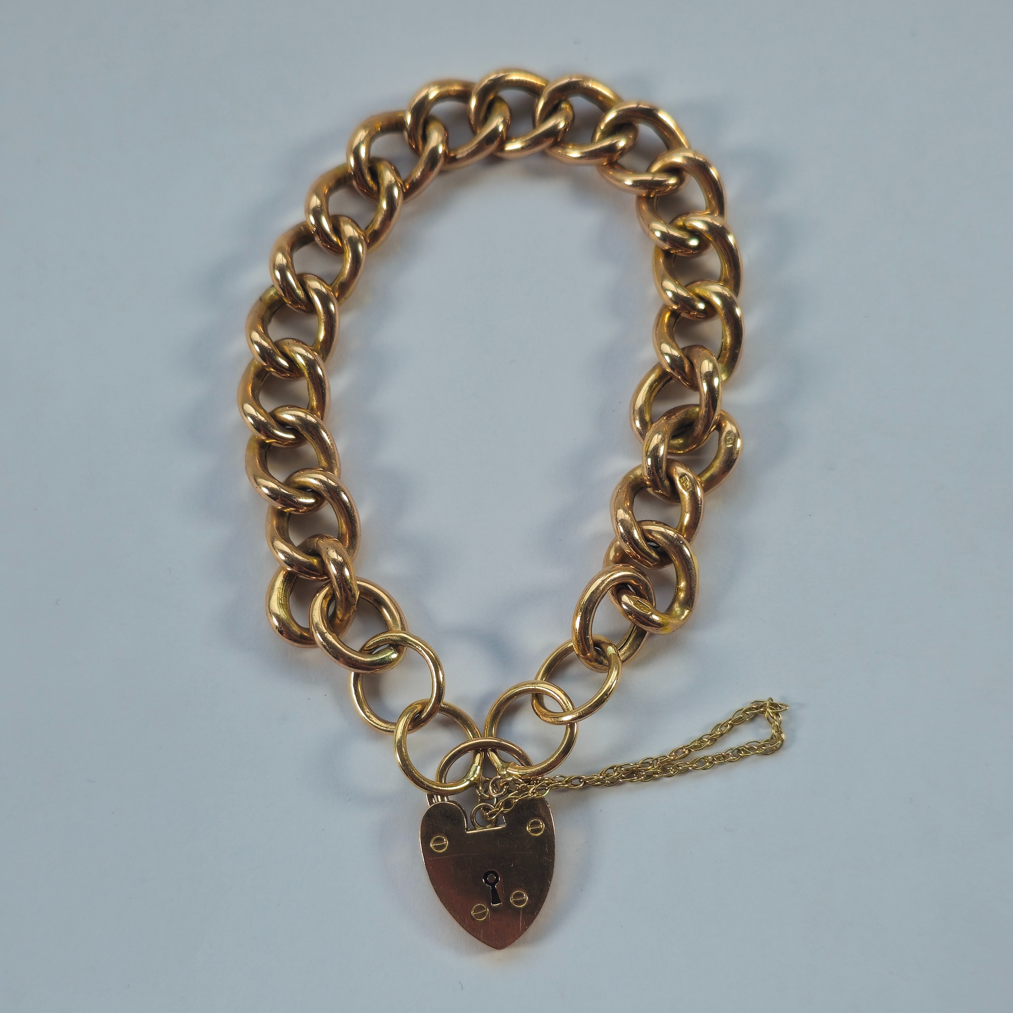 Product photo for 9ct Rose Gold Hollow Oval Twisted Curb Heart Padlock Bracelet