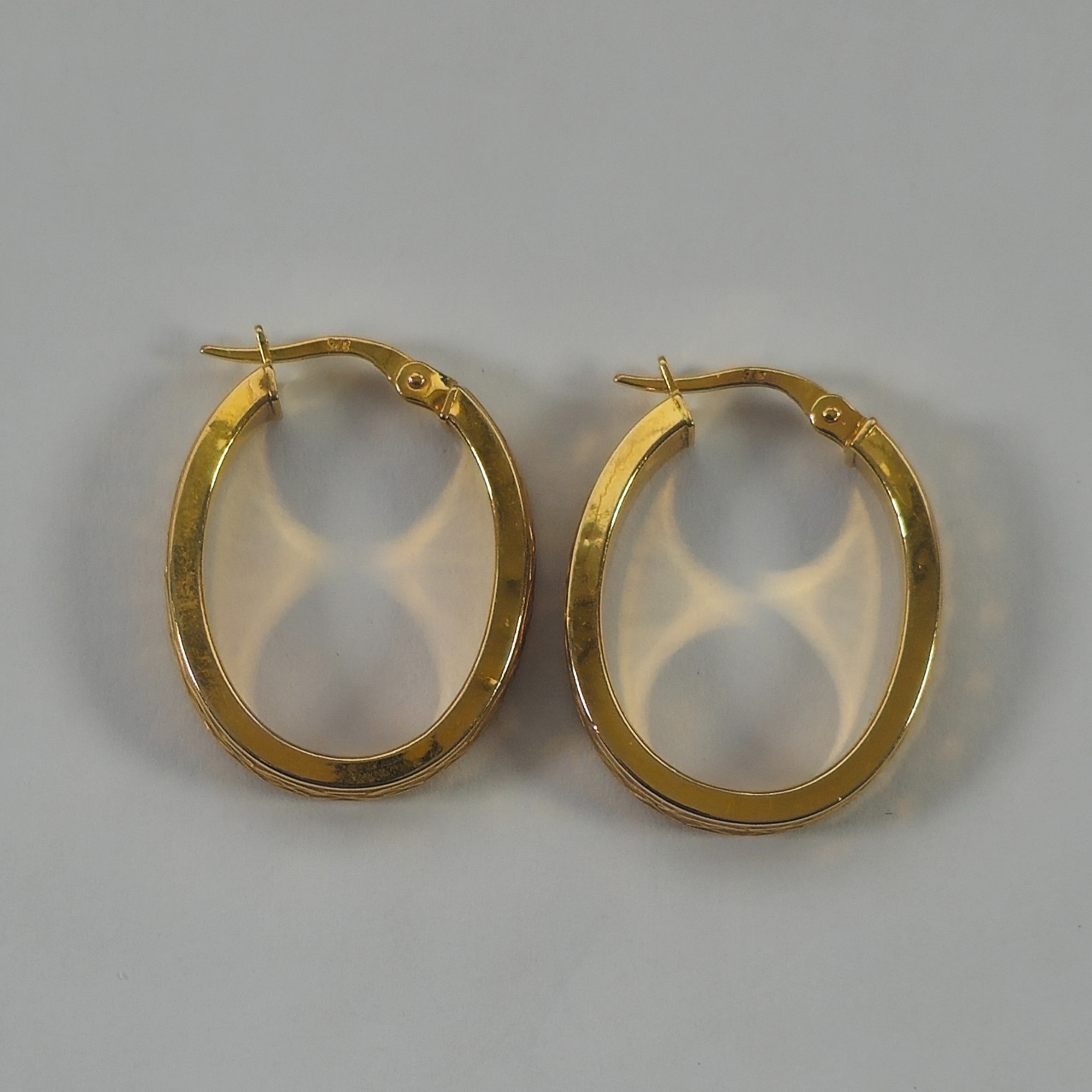 Product photo for 9ct Gold Celtic Pattern Oval Hoop Earrings