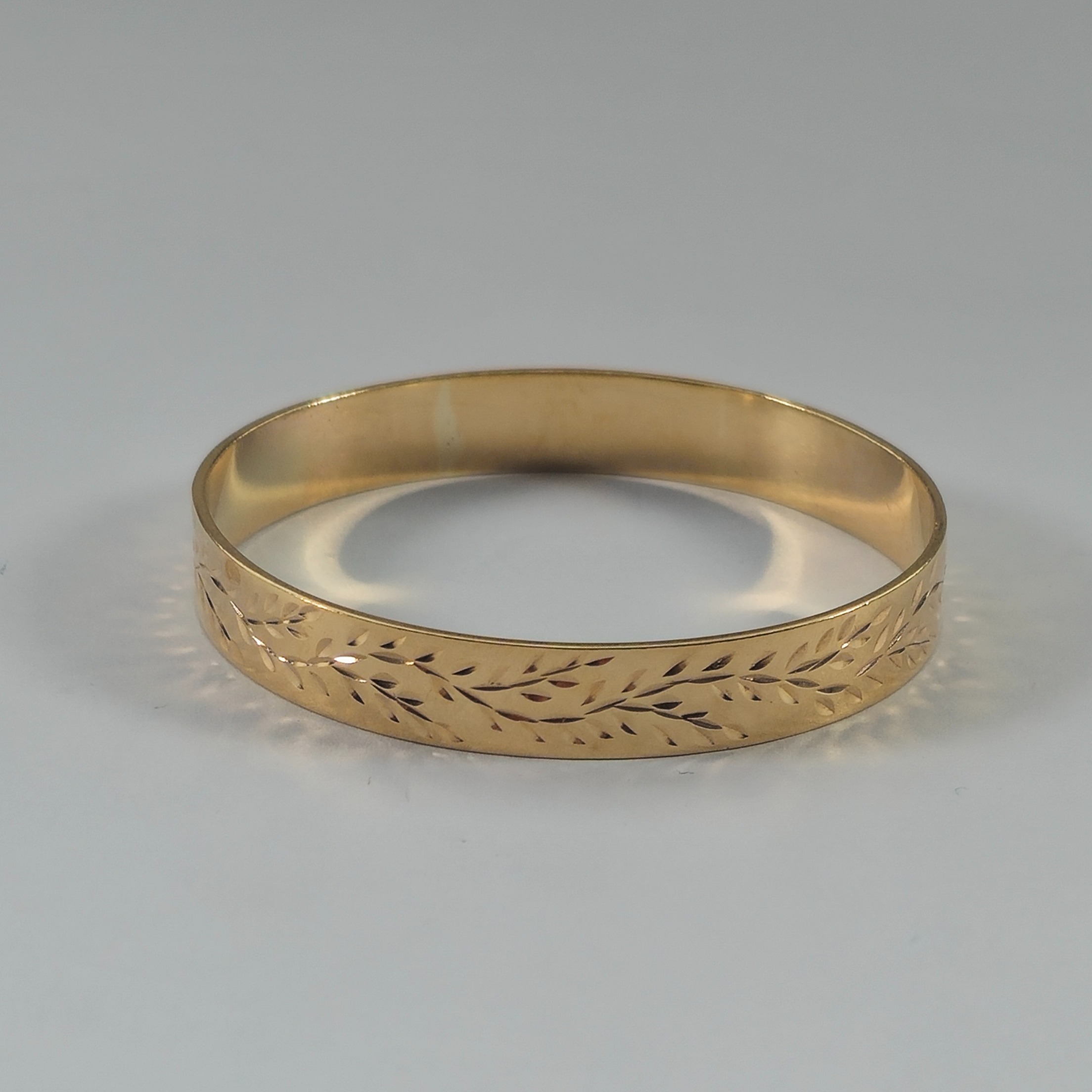 Product photo for 9ct Gold Olive Leaf Pattern Baby Slave Bangle