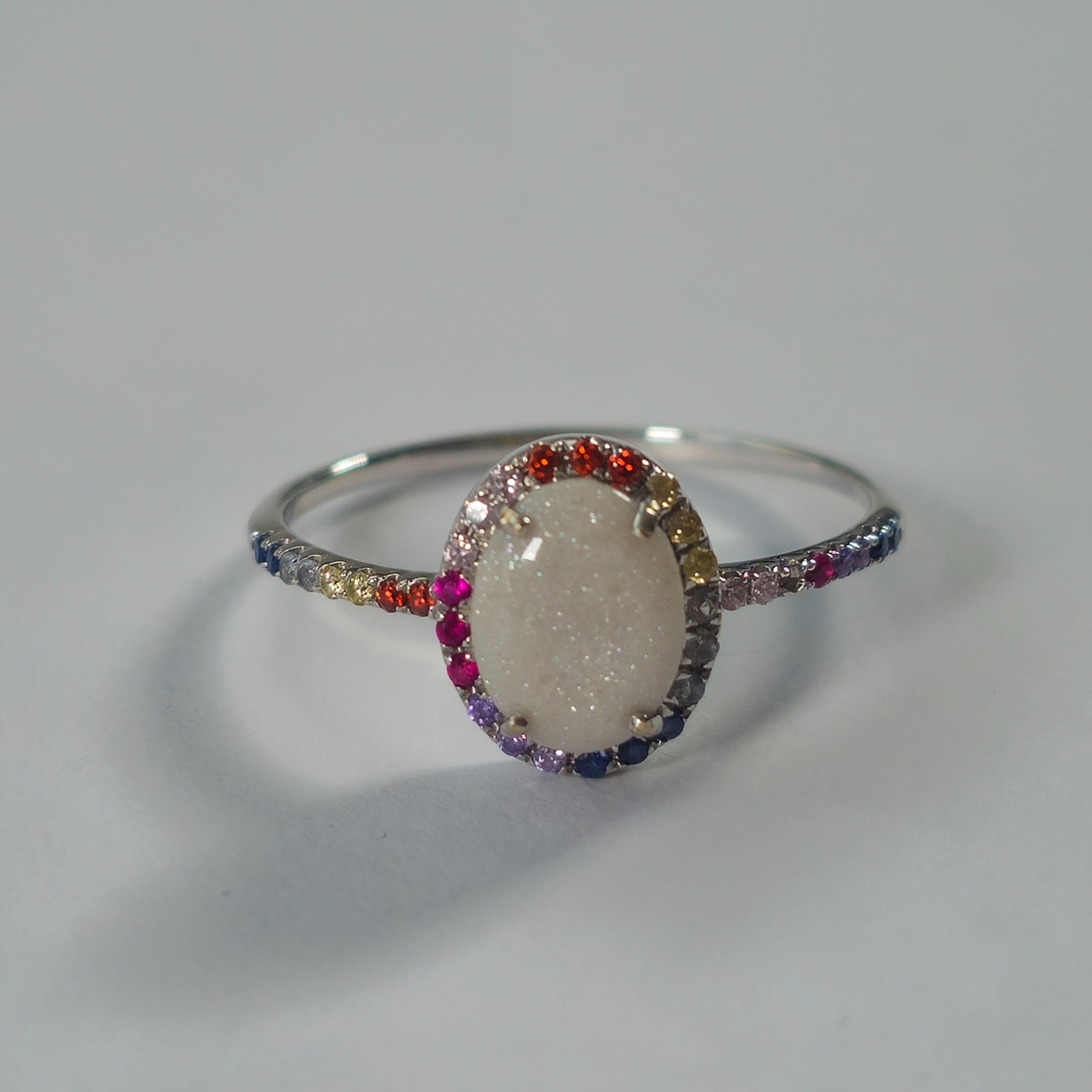 Product photo for 14ct White Gold Oval Glittery Stone & Small Multi Coloured Engagement Style Ring Size P