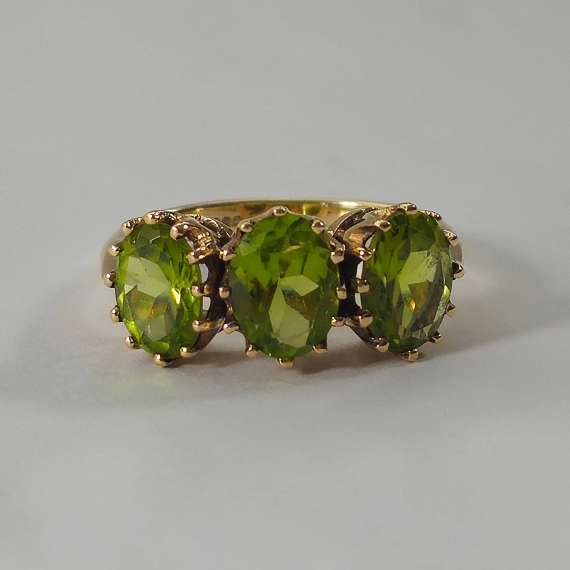 Product photo for 9ct Gold Oval Green Peridot Trilogy Ring Size O