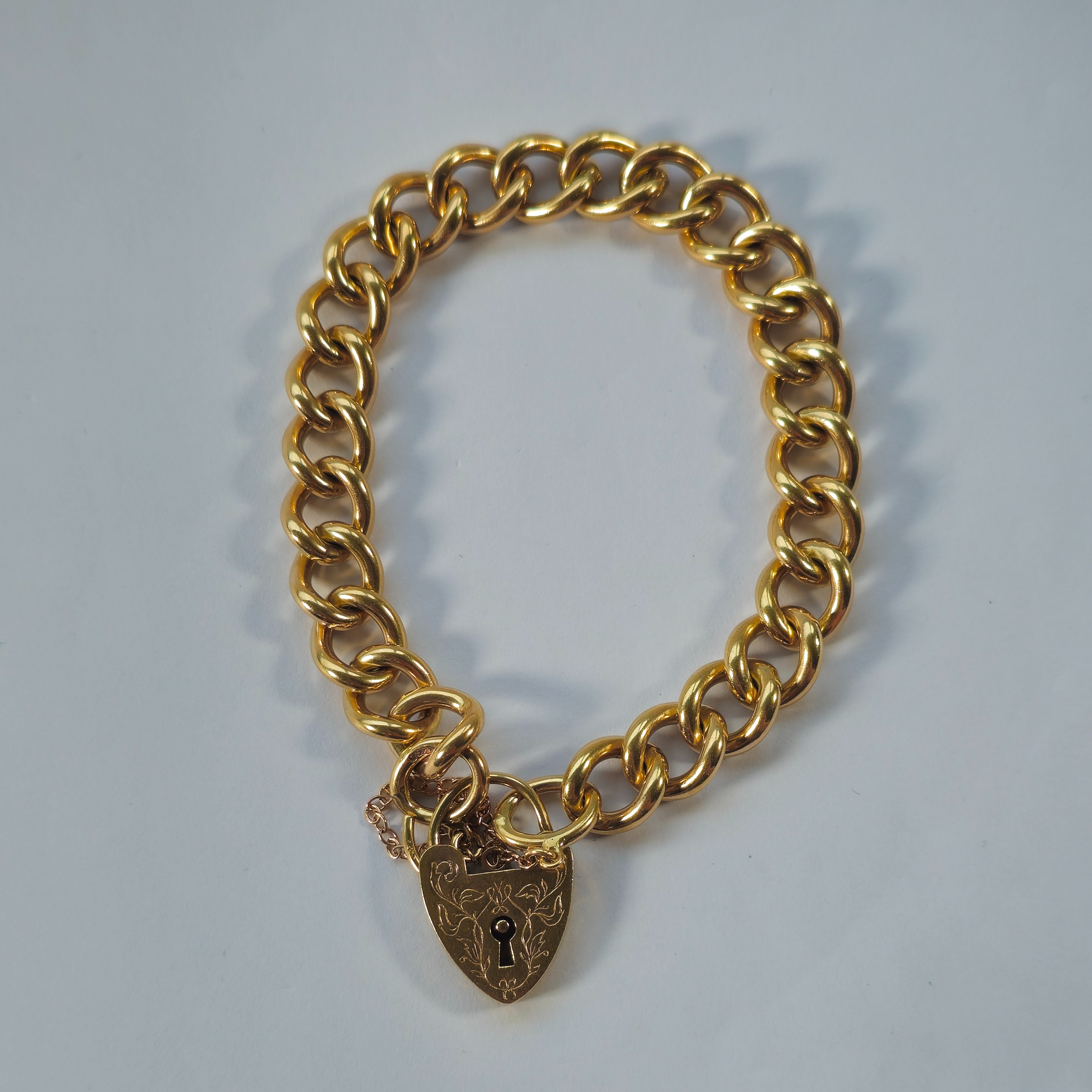 Product photo for 9ct Gold Oval Twisted Links Heart Padlock Bracelet