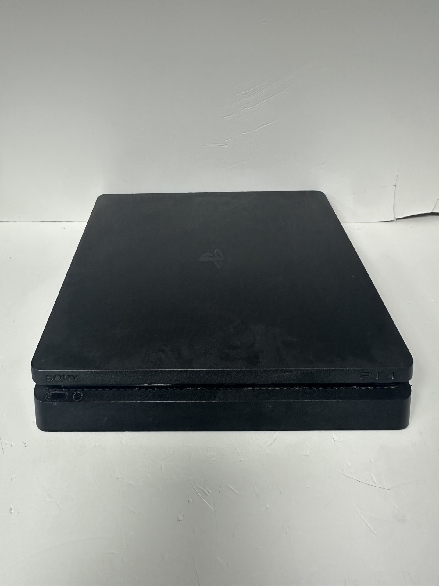 Product photo for ps4 slim 500gb black with the controller unboxed