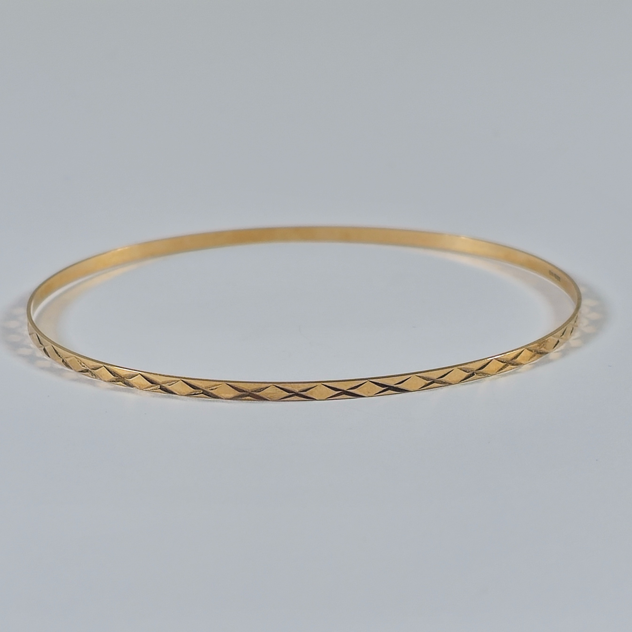 Product photo for 9ct Gold Star Pattern Slim Stacking Bangle