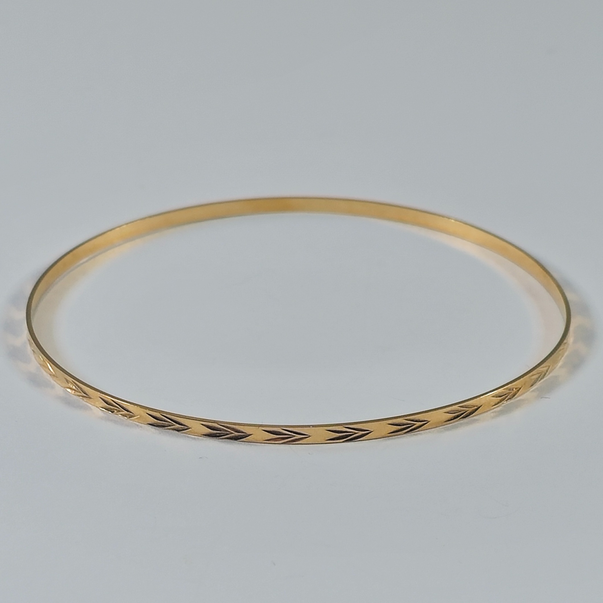 Product photo for 9ct Gold Double Heart / Arrows Pattern Slim Stacking Bangle