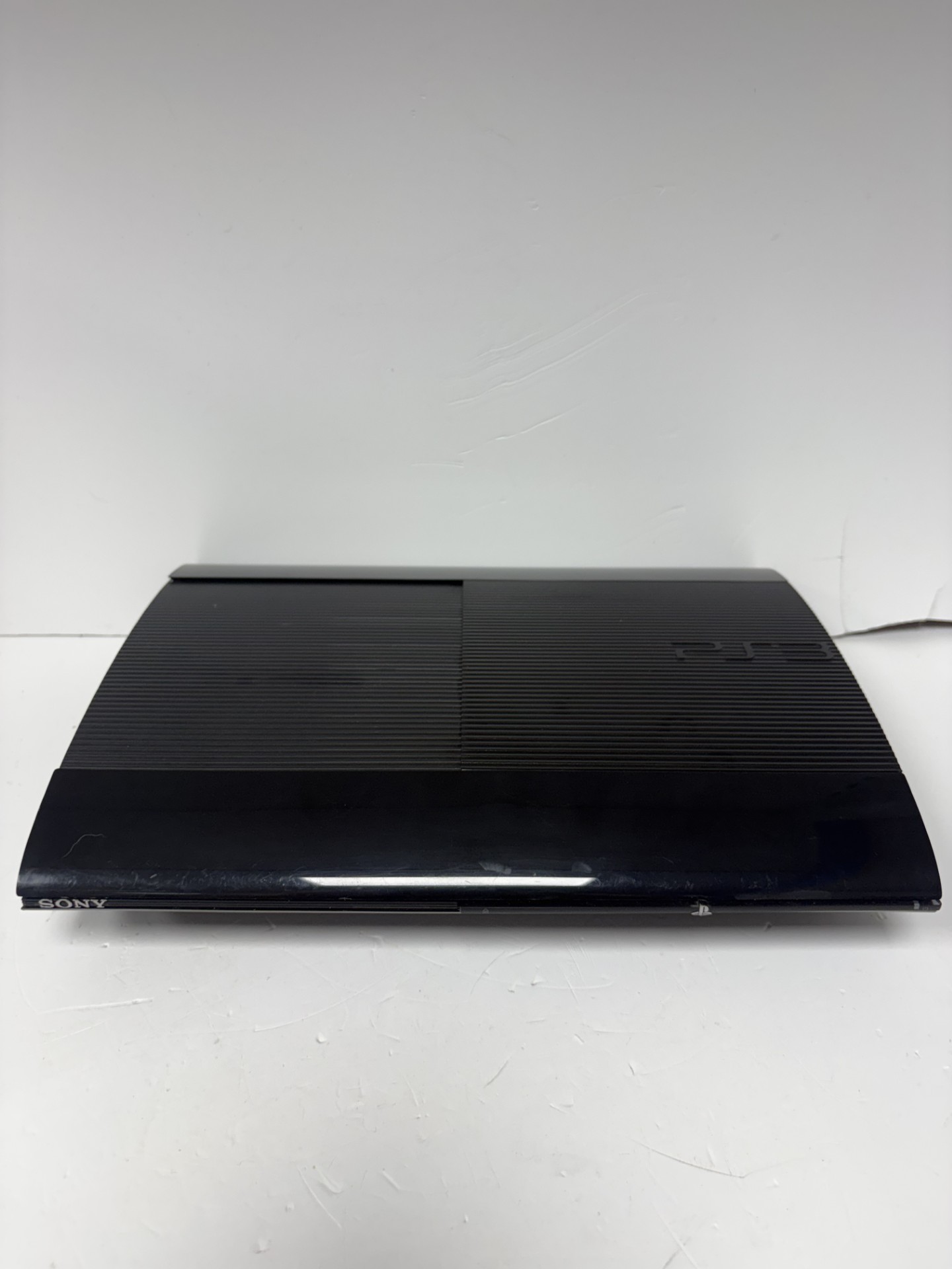 Product photo for SONY ps3 SLIM console black unboxed with wires and controller